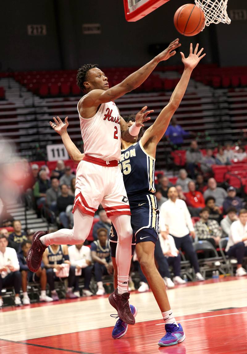Northern Illinois' Zarique Nutter passes from the baseline as Akron’s Enrique Freeman defends during their game Tuesday, Jan. 2, 2024, in the Convocation Center at NIU in DeKalb.