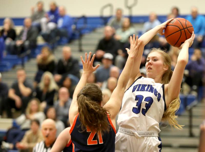 Geneva’s Lauren Slagle (33) passes the ball from under the basket during a home game against Naperville North on Tuesday, Nov. 29, 2022.