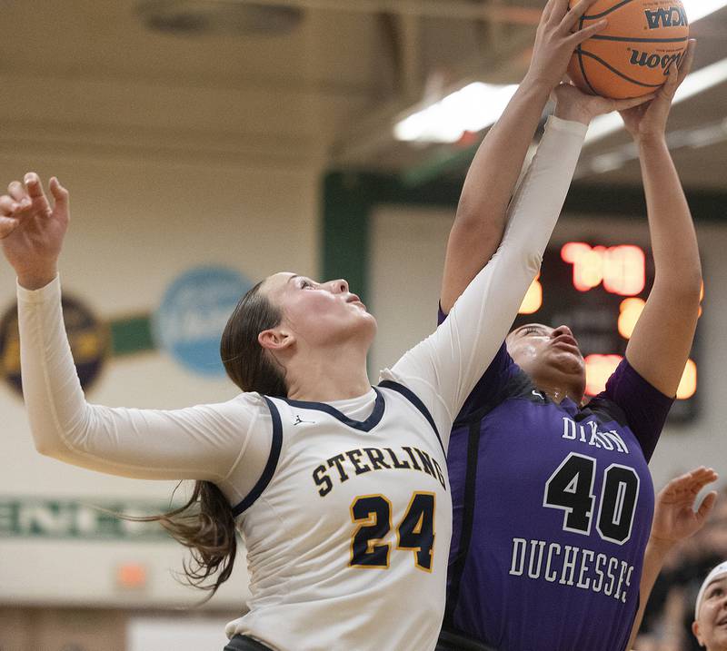 Sterling’s Madison Austin and Dixon's Hallie Williamson fight for a rebound Thursday, Feb. 27, 2025, during the Class 3A girls Sectional title at Rockford Boylan High School.
