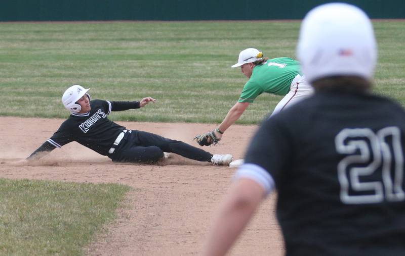 Kaneland's Preston Popovich slides safely back into second base while his teammate Jack Wituk looks on as L-P's Kaedin Bond misses the tag on Thursday, April 11, 2024 at Huby Sarver Field in La Salle.
