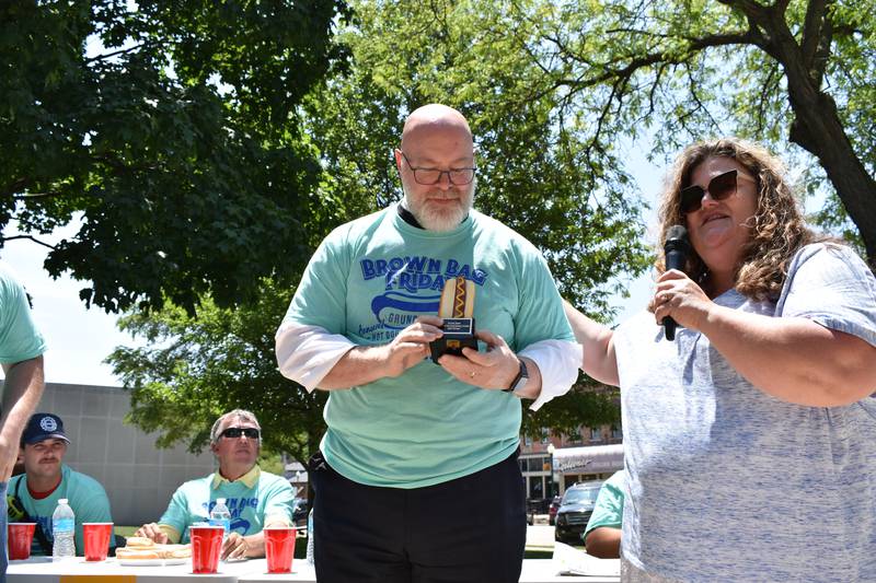 State's Attorney Russell Baker with his trophy for winning the hot dog eating contest.