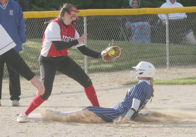 Newark's Bailey Schutter slides under the tag of Earlville's Riley Kelly during the Class 1A Regional final on Thursday, May 22, 2025 at Indian Creek High School in Shabbona.