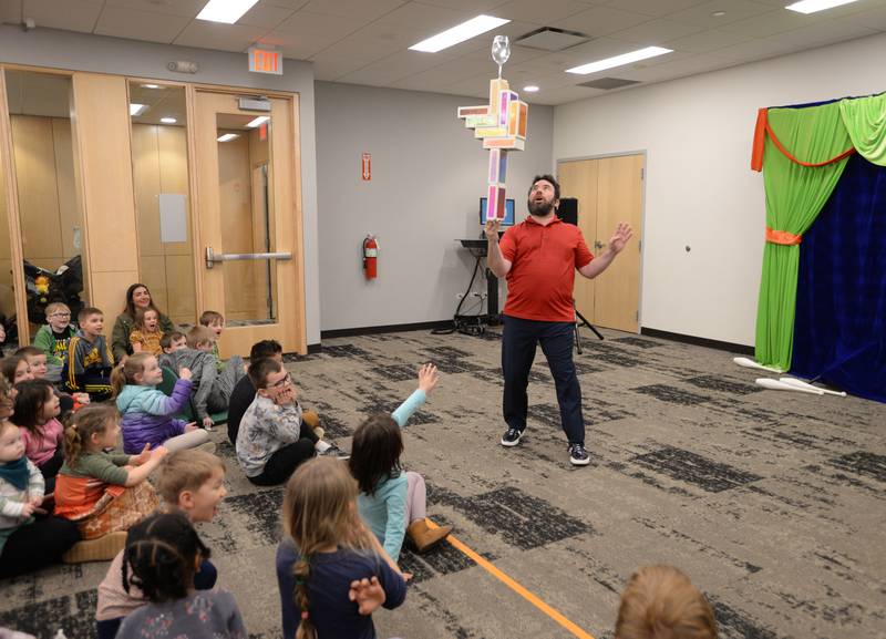 Jason Kollum demonstrates how to balance during the See a Juggler, Be a Juggler held at the Glen Ellyn Library Saturday April 5, 2025.