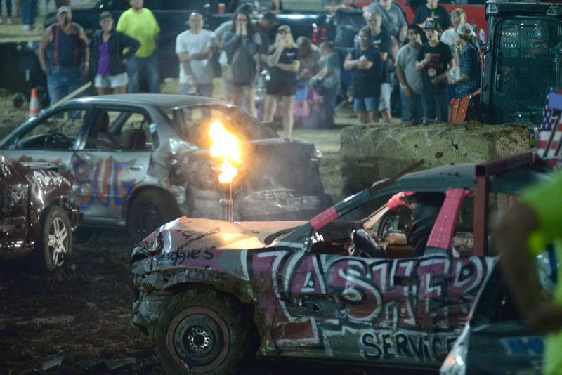 Flames shoot out of the exhaust of one of the cars during the Compact Heat at the Ogle County Fair's demolition derby on Saturday, Aug. 2, 2025.