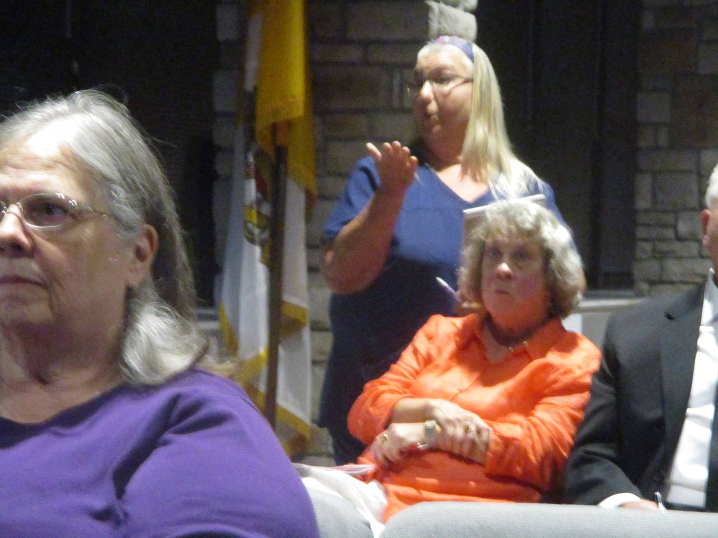 Resident Jori Gura (standing) makes a point during the community meeting at Joliet Catholic Academy on Wednesday. Sept. 24, 2025
