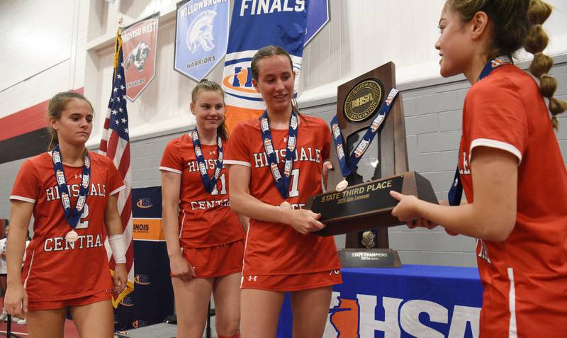 Left to right, Hinsdale Central captains Peyton Moncrief, Logan O'Connor, Regan Kearney and Ella Parker-Briones accept their team’s trophy after defeating Crystal Lake Central Coop during the third-place game of the girls lacrosse state finals at Hinsdale Central High School on Saturday, June 7, 2025.