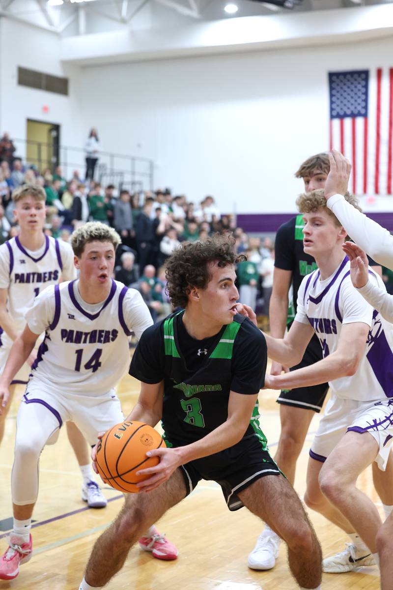Bishop McNamara's Preston Payne looks to pass a rebound during the Fightin' Irish's 61-24 victory over Manteno on Tuesday, Jan. 13, 2026.
