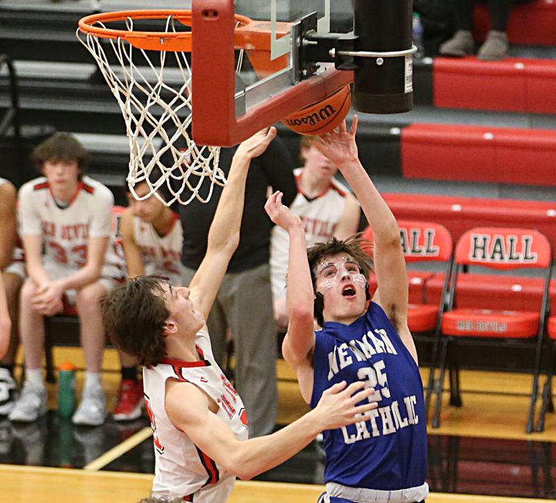 Newman's Kenny Boesen drives to the hoop as Hall's Braden Curran defends on Friday, Feb. 3, 2023 at Hall High School.