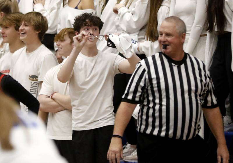 Burlington Central student Ben Davis holds up his glasses referee Scott Sobeski during a Fox Valley Conference girls basketball game on Friday, Dec. 15, 2023, at Burlington Central High School. I like how the referee smiles and takes the glasses joke in stride as he referred a close game.