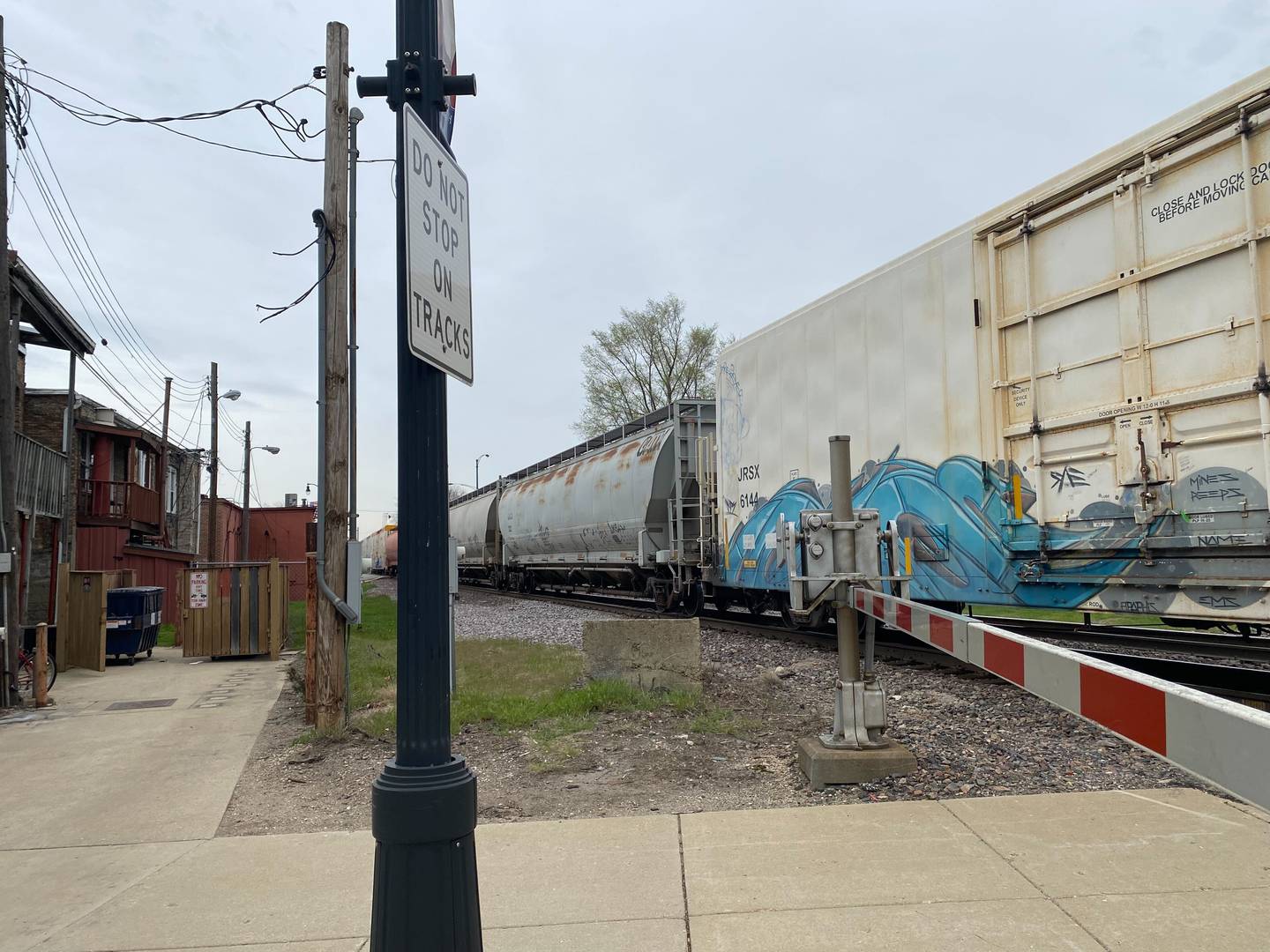 A stopped train blocks a Third Street intersection in downtown DeKalb Friday, April 26, 2024.
