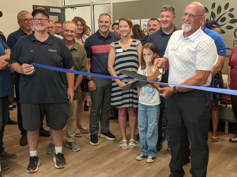 Oswegoland Park Board President Dave Behrens cuts the ribbon during a July 28 ribbon-cutting ceremony for the Oswegoland Park District's Grove Administration & Operations Center at 3220 Grove Road in Oswego. 
The ceremony was hosted by the Oswego Area Chamber of Commerce.