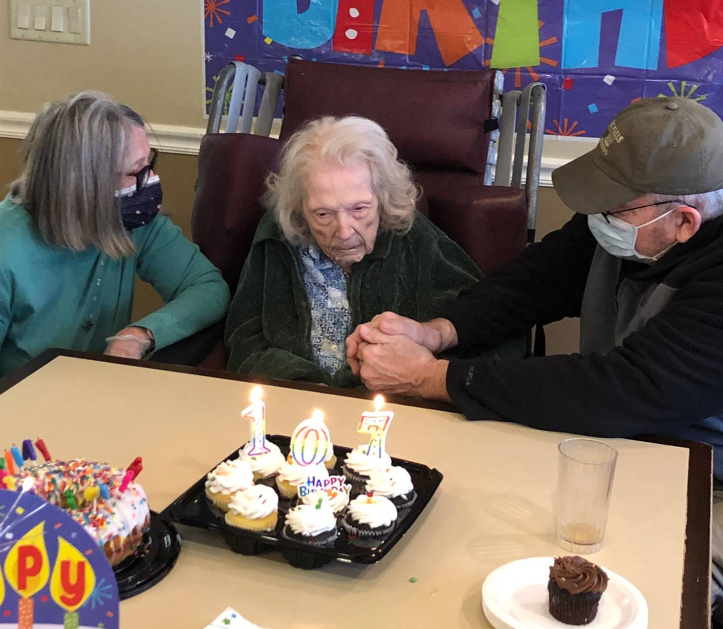 Dorothy Wellman, center, celebrates her 107th birthday at Bickford Assisted Living and Memory Care in Oswego on Oct. 18, 2022.