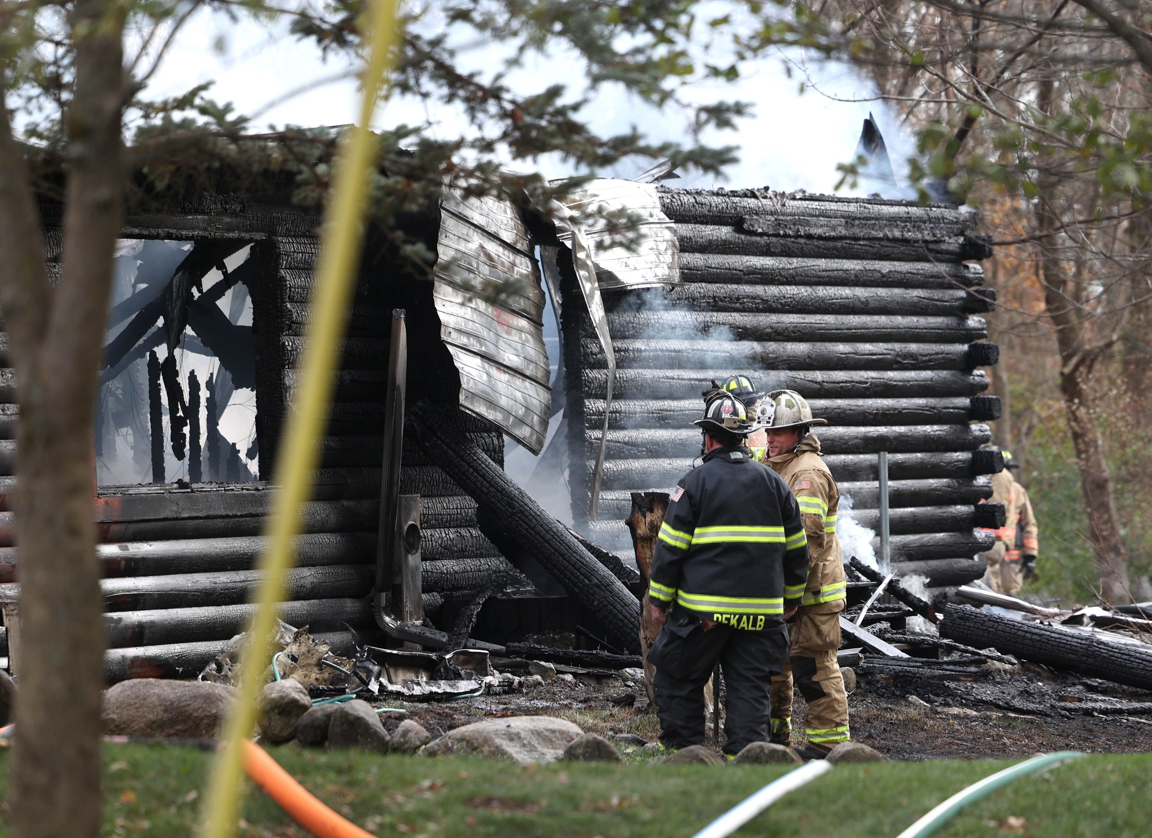 Smoke continues to pour from a house that was destroyed by fire Thursday, Nov. 13, 2025, near Shabbona Grove Road in Shabbona. Several local departments responded to the general alarm structure fire.