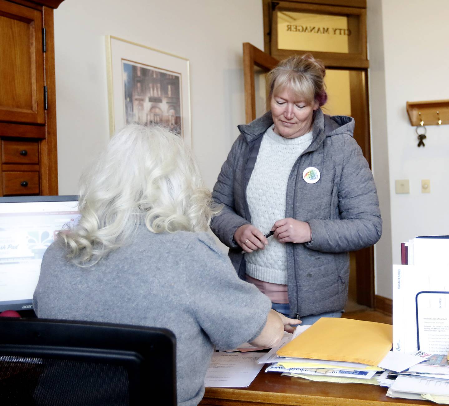 Melissa McMahon, who is running for the Woodstock City Council waits for Jane Howie, an executive assistant and election official with the city, to receive her candidate filing papers on Monday, Nov. 28, 2022, at City Hall. Monday was the last day to file for the cities of Woodstock and Crystal Lake.