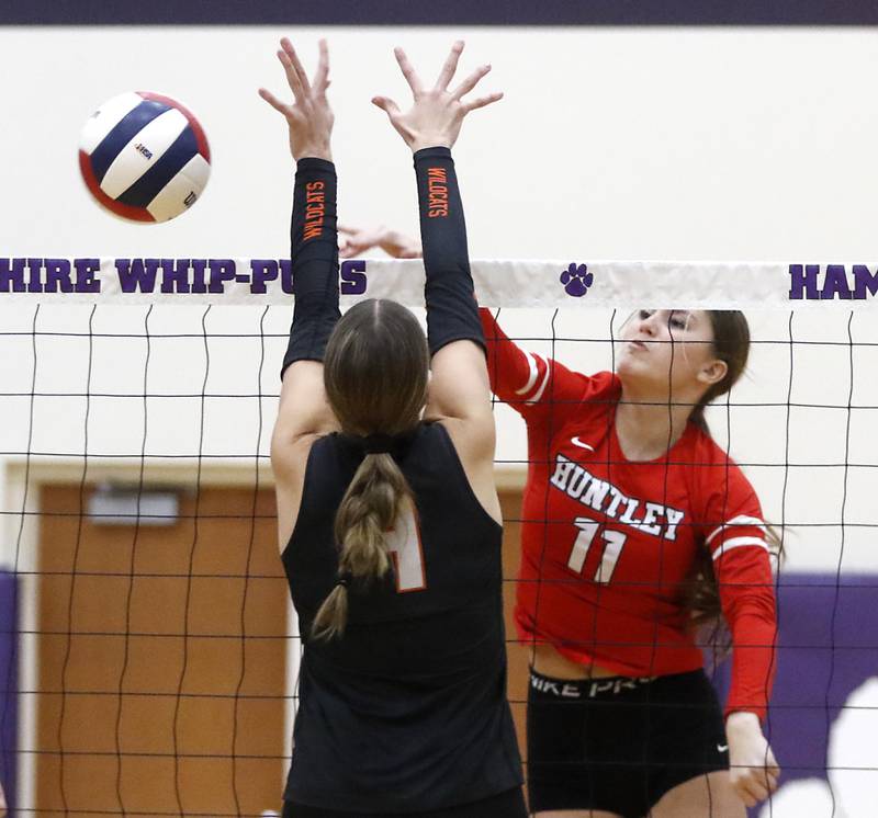 Huntley's Riley Galanis tries to hit the ball past Libertyville's Vivian Lang during an IHSA Class 4A Hampshire Sectional semifinal volleyball match on Tuesday, Nov. 4, 2025, at Hampshire High School.