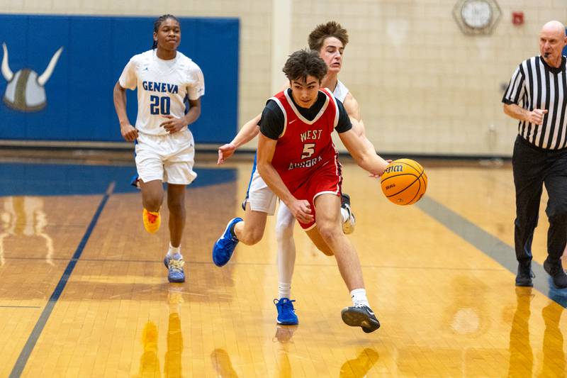 West Aurora's Caelan Reynolds tries to avoid the steal by Geneva's Nathan Palmer on Monday, Jan. 19,2026 in Geneva.
