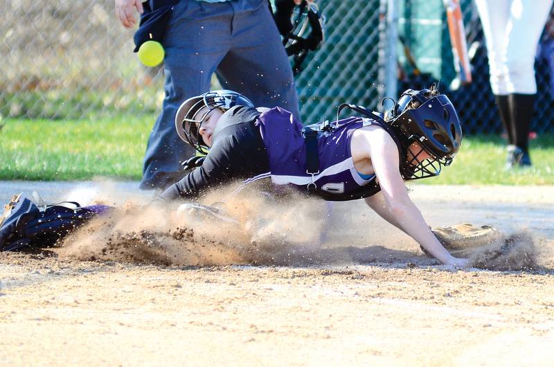 A Rock Falls runner slides in safely at home in a game March 19, 2012 against Dixon.