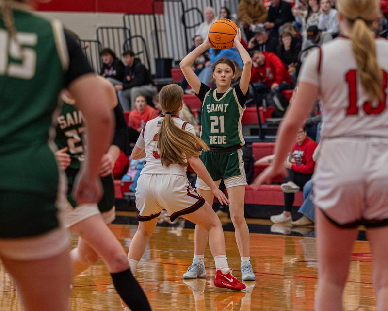 Parker McClain (21) of St. Bede holds ball over-head as Leah Pelka (3) of Hall defends on Saturday, January 31, 2026 at Hall High School in Spring Valley.