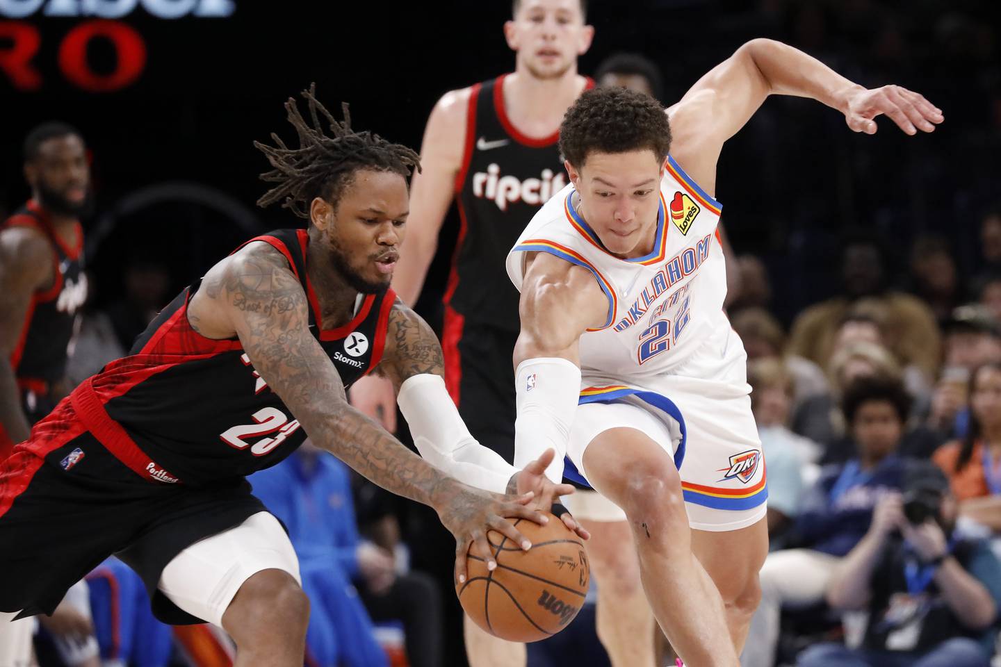 Portland Trail Blazers guard Ben McLemore (23) and Oklahoma City Thunder forward Isaiah Roby (22) battle for the ball during the second half Tuesday, April 5, 2022, in Oklahoma City. (AP Photo/Garett Fisbeck)
