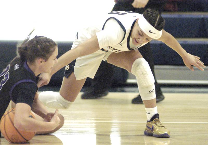 Plano's Josie Larson and Sterling's Joslynn James fight for a loose ball.The Sterling Golden Warriors faced off against Plano Lady Reapers in an IHSA 3A Regional girls final at Musgrove Fieldhouse in Sterling on February 20, 2025. Sterling won the game 70-38.