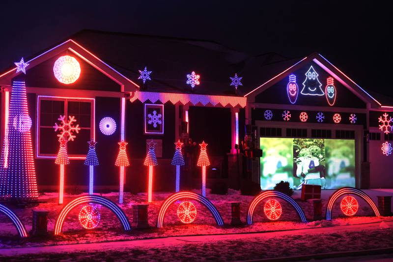 Chicago Bears highlights play on the garage door during light show put together by Tim Caravia and his family Friday, Jan. 16, 2025, at his home on Dustin Drive in Sycamore. The show will run from 5:30 to 9:00 p.m. most days until the Bears season ends.