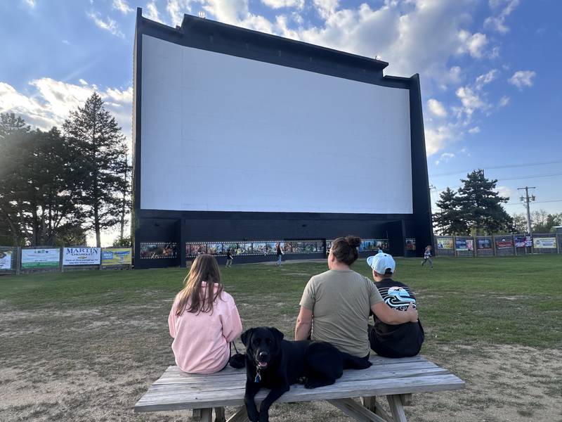 Becca Klutts hangs out with her daughter, Carrington, son, Asher, and family dog, Jetta, before the start of the “Twister” and “Twisters” double feature at the McHenry Outdoor Theater Friday, May 8. The theater will be open seven days a week starting Memorial Day weekend.