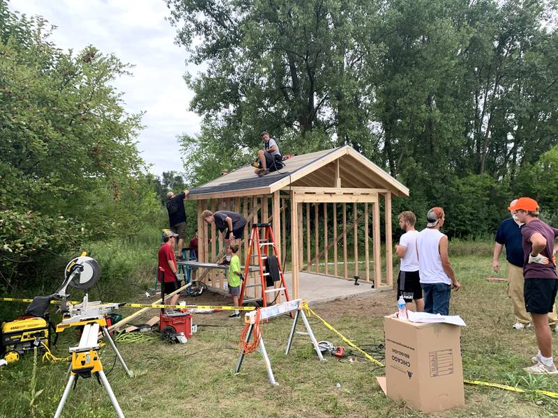 Volunteers work with Sugar Grove resident Christopher Eby to replace a dilapidated shed for the Sugar Grove United Methodist Church (SGUMC). The project was Eby’s his Eagle Project for Sugar Grove Boys Scouts of America Troop No. 41.