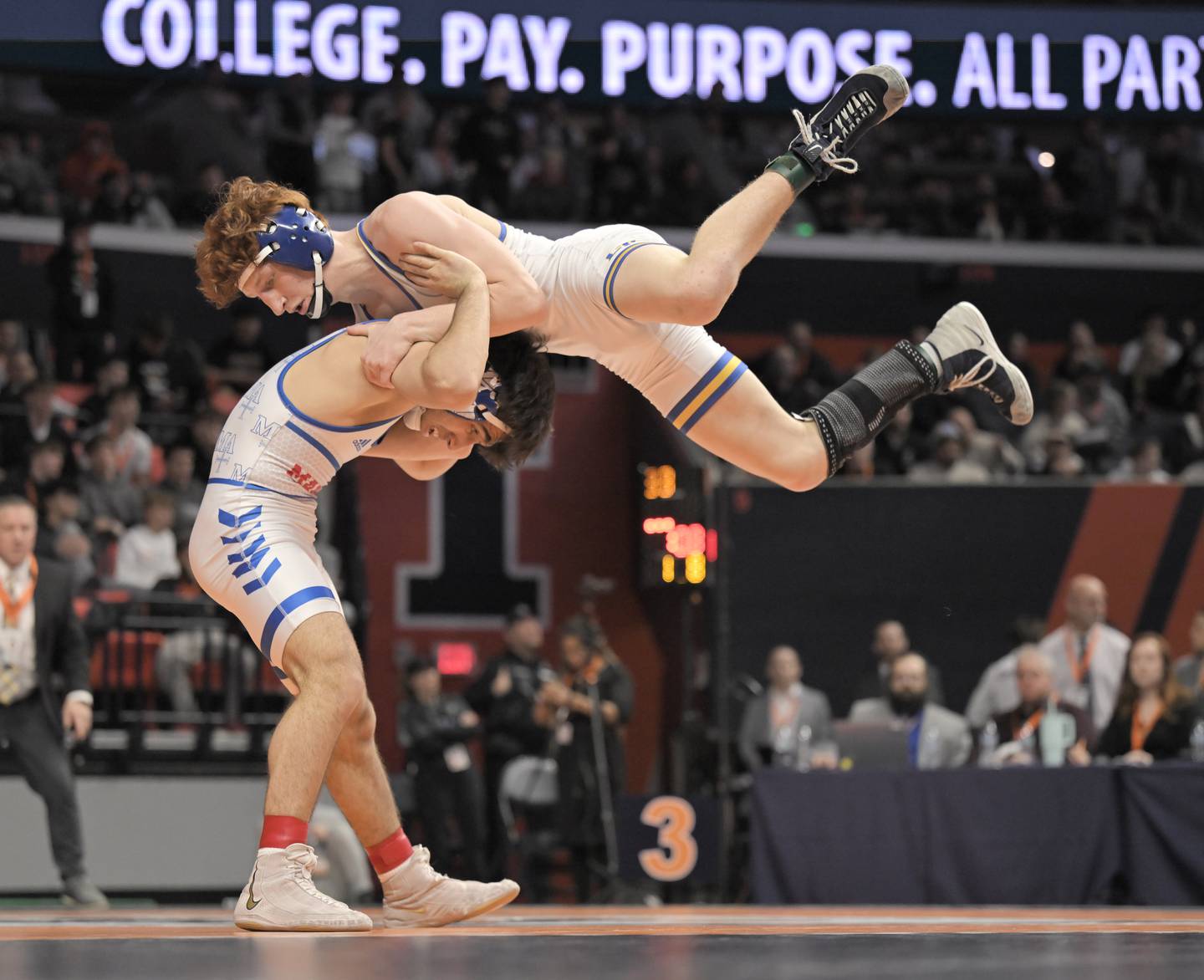 Marmion’s Zach Stewart lifts Lyons Township’s Griff Powell in the Class 3A 138-pound bout at the boys IHSA wrestling finals at State Farm Center in Champaign on Saturday, Feb. 21, 2026.