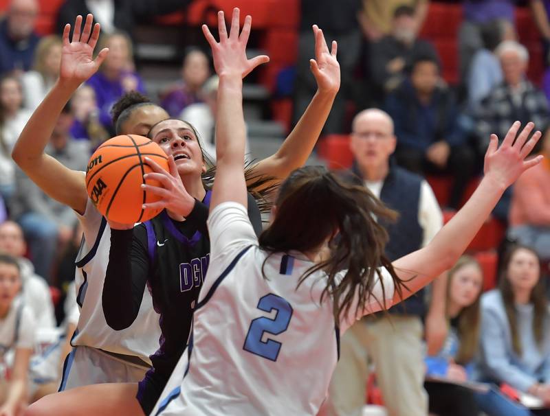 Downers Grove North’s Campbell Thulin tries to get a shot off while sandwiched between Nazareth’s Mia Gage and Samantha Austin during the Class 4A Hinsdale Central Sectional final game on February 26, 2026 at Hinsdale Central High School in Hinsdale.