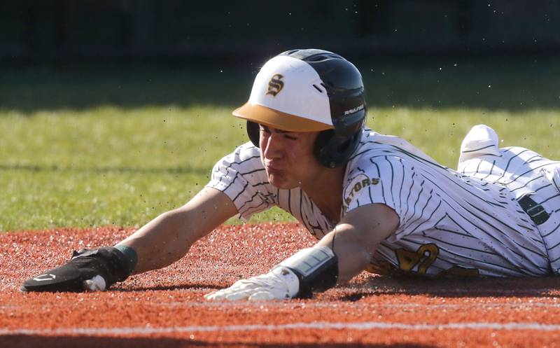Crystal Lake South's Michael Rathjen slides into home plate to score a run during a Fox Valley Conference baseball game against Prairie Ridge on Friday, May 15, 2026, at Crystal Lake South High School.