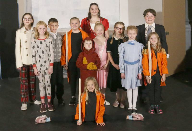 From left: Lizzie Trotter as Mrs. Bloom, Rose Tracey as Hannah Bloom, Maddux Bell as Mr. Bloom, Sadie Tracey as ensemble wooden soldier, Stella Funderberg as Mrs. Ethel Haney, Nicholas Johnson as ensemble stuffed puppy, Hannah Noord as Clara, Ellie Denton as Ivy, Ella Johnson as Noelle, Duilio Alvarado as Drake Haney, Isabella Bence as ensemble wooden soldier, June Gifford (in the splits) as ensemble wooden soldier. pose for a photo during a rehearsal of “The Magic of Christmas” the Children’s Christmas Musical on Tuesday, Nov. 11, 2025 at the Prairie Art’s Center in Princeton. Not pictured in the photo were Truly Taylor as Holly, AJ Lind as Fuzzy, Harvey Smith as Captain Frederic, Delilah Gyurkovics as Lieutenant Frances, Allison Anderson as Elaine Foxglove.
The Children’s Christmas Musical will be presented at the at Prairie Arts Center December 5-7.  December 5 at 6p.m., December 6 at 6p.m. and December 7 at 2p.m. Tickets are $15 for adults and $10 for children. To purchase tickets, call 719-290-0954. “The Magic of Christmas” A Community Theater Children’s Christmas Musical written and directed by Rachel Gorenz-Johnson.