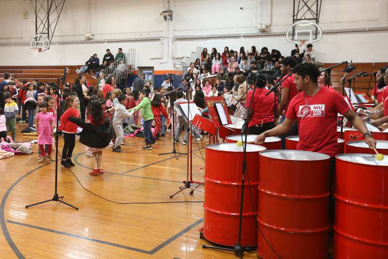 Students dance while listening to music from the Northern Illinois University Steelband  on Friday, Feb. 14, 2025 at DePue School.