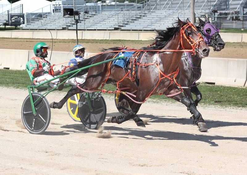 Heavy Pressure, (front) driven by Archie Buford, wins the Sandwich Free For All Pace during harness racing Wednesday, Sept. 7, 2022, on opening day of the Sandwich Fair. The fair continues this week through Sunday.