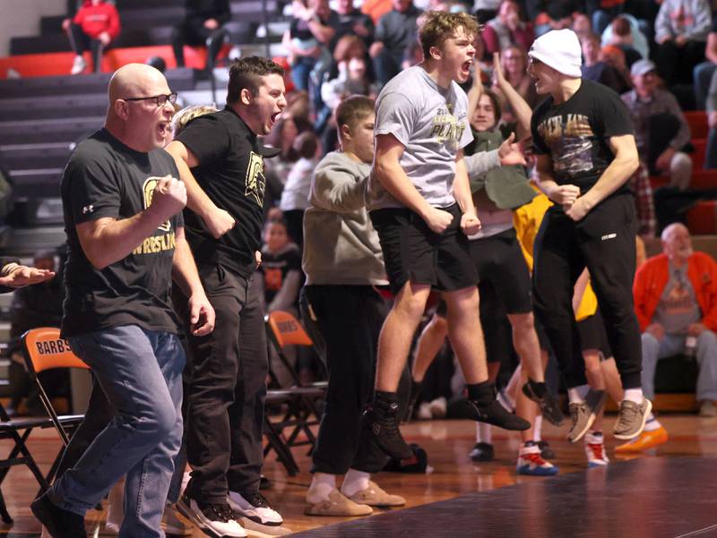 Sycamore coaches and wrestlers celebrate a win in one of the matches during their dual with DeKalb Friday, Jan. 17, 2025, during their match at DeKalb High School.