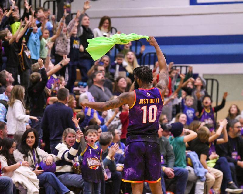 Harlem Wizards player Just Do It flings a shirt into the stands on Sunday Jan. 19. 2025, after switching sides during the game to help out the Downers Grove staff in the third quarter held at Downers Grove South High School.
