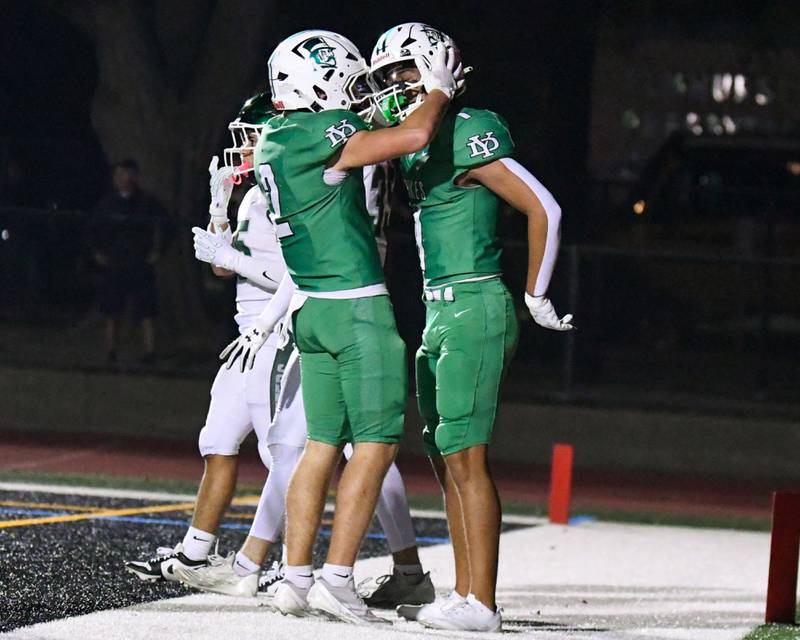 York's Simon Kodosky, right, gets congratulated by teammate Anthony Massel after Simon scored a touchdown during the game on Friday Oct. 17, 2025, while taking on Glenbard West held at York High School.