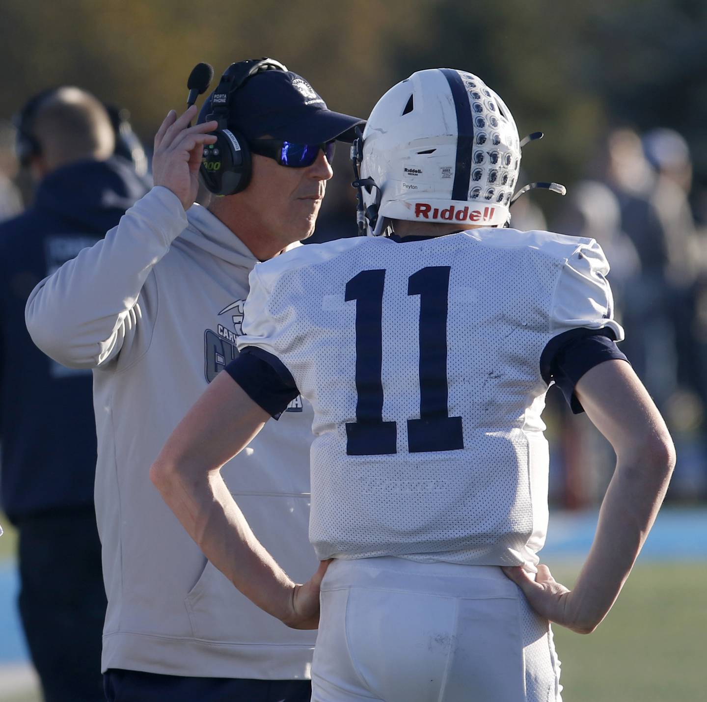 Cary-Grove Head Coach Brad Seaburg talks to his son, quarterback Peyton Seaburg, during a IHSA Class 6A semifinal playoff football game on Saturday, Nov. 18, 2023, at Lake Zurich High School.