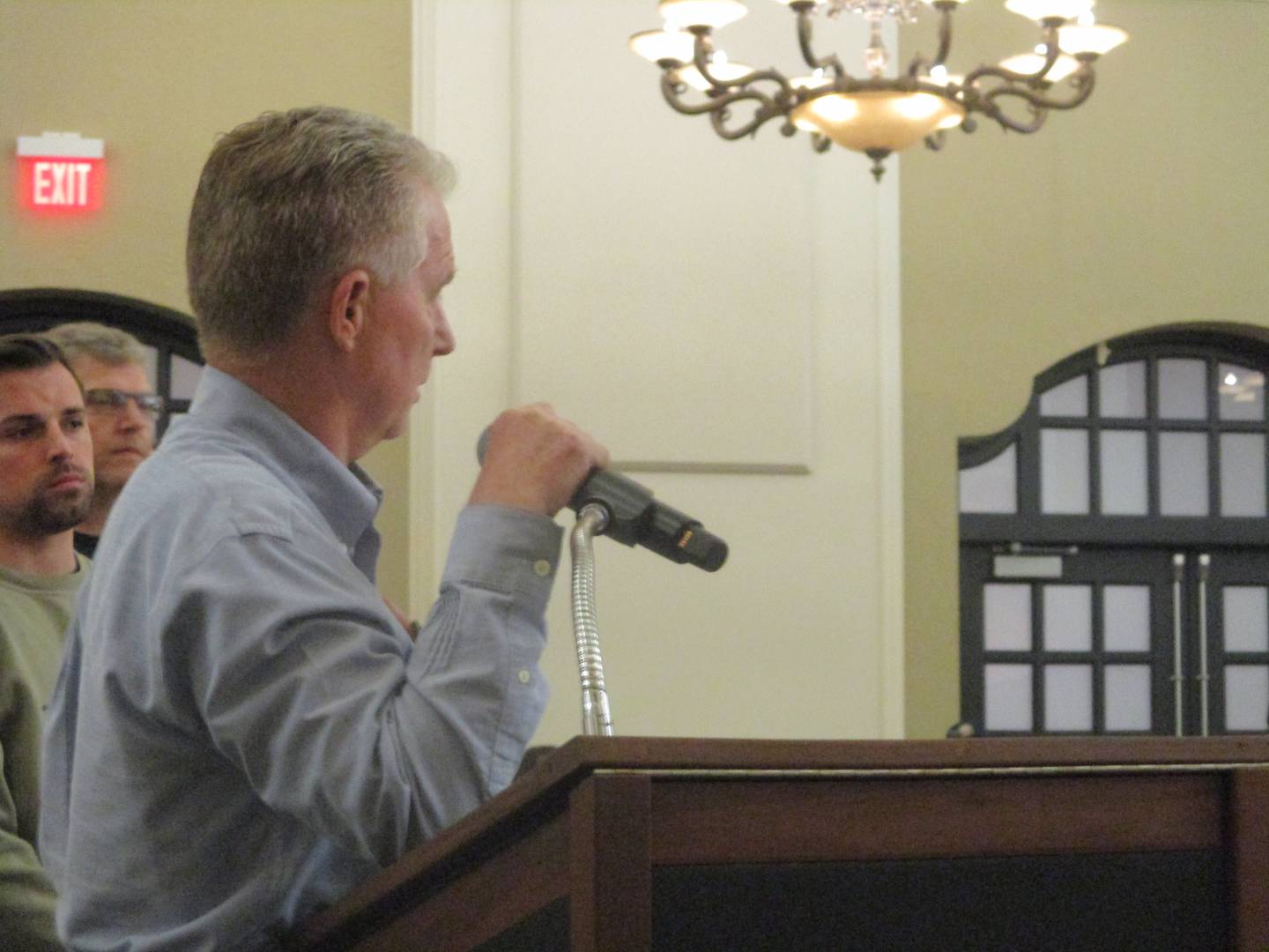 Farmer Mark Fecht, who has land in Wilton Township, turns to speak to opponents of a proposed 6,100-acre solar complex in Will County during a public hearing Monday on the project. March 30, 2026