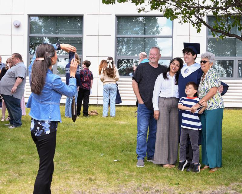 An Oswego East graduate poses for a photo with others after the graduation ceremony was completed on Saturday May 17, 2025, held at the Convocation Center in DeKalb.