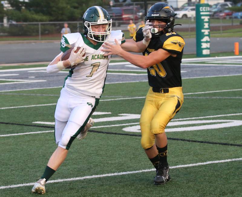 St. Bede's Alex Ankiewitz stiff arms Tuscola's Tavi Neamtu during a carry on Friday, Aug. 25, 2023 at Tucci Stadium  in Bloomington.