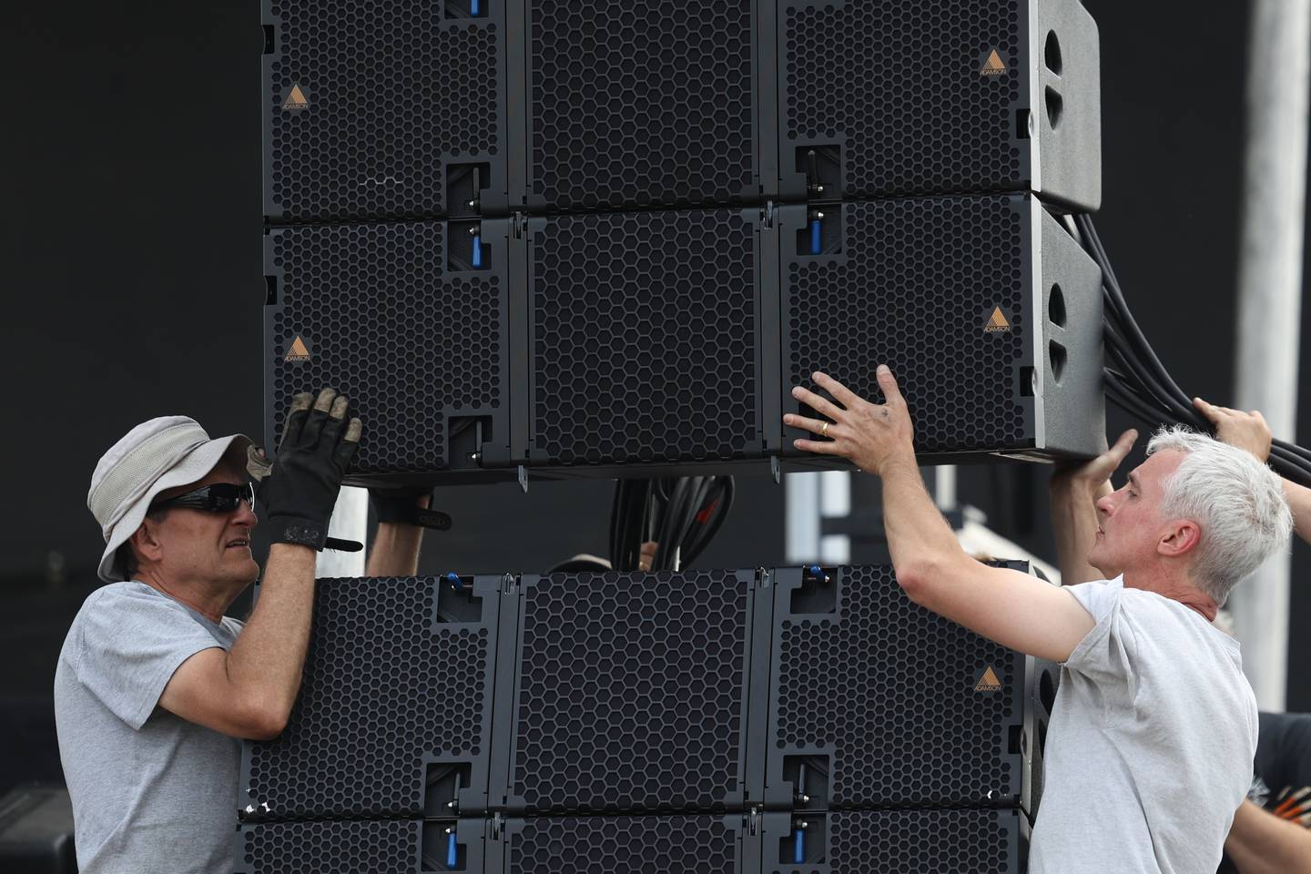 A crews lower a speaker into place at the music stage during the Taste of Joliet setup on Thursday, June 22, 2023.