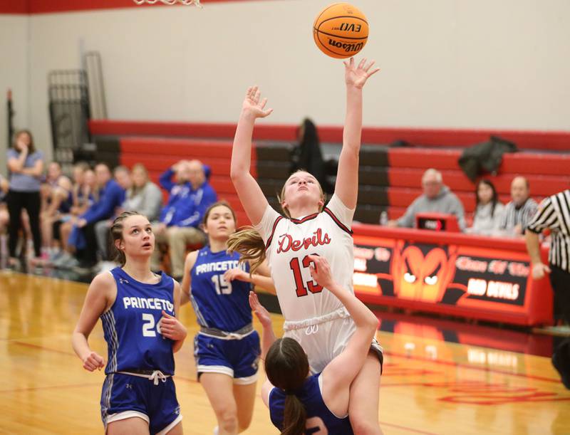 Hall's Caroline Morris lets go of the ball to score on a drive to the hoop as Princeton's Camryn Driscoll draws a foul on Monday, Jan. 6, 2025 at Hall High School.