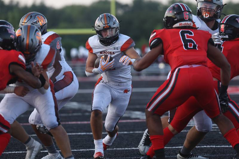 Minooka’s Joseph Partridge runs up the middle against Bolingbrook. Friday, Aug. 26, 2022, in Bolingbrook.
