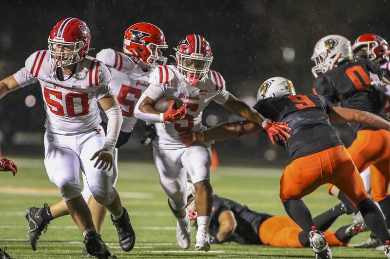 Yorkville's T.J. Harland (5) runs up the middle during football game between Yorkville at Plainfield East Friday, Sept 19, 2025 in Plainfield.