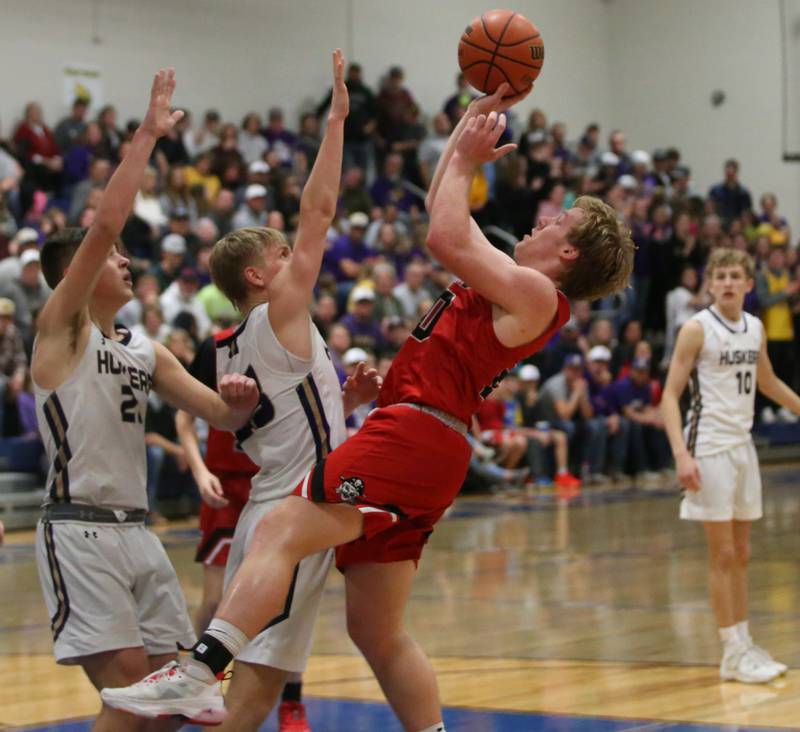 Earlville's Griffin Cook shoots a shot over Serena's Beau Raikes and Tanner Faivre during the Little Ten Conference Championship on Friday, Feb. 2, 2024 at Somonauk High School.