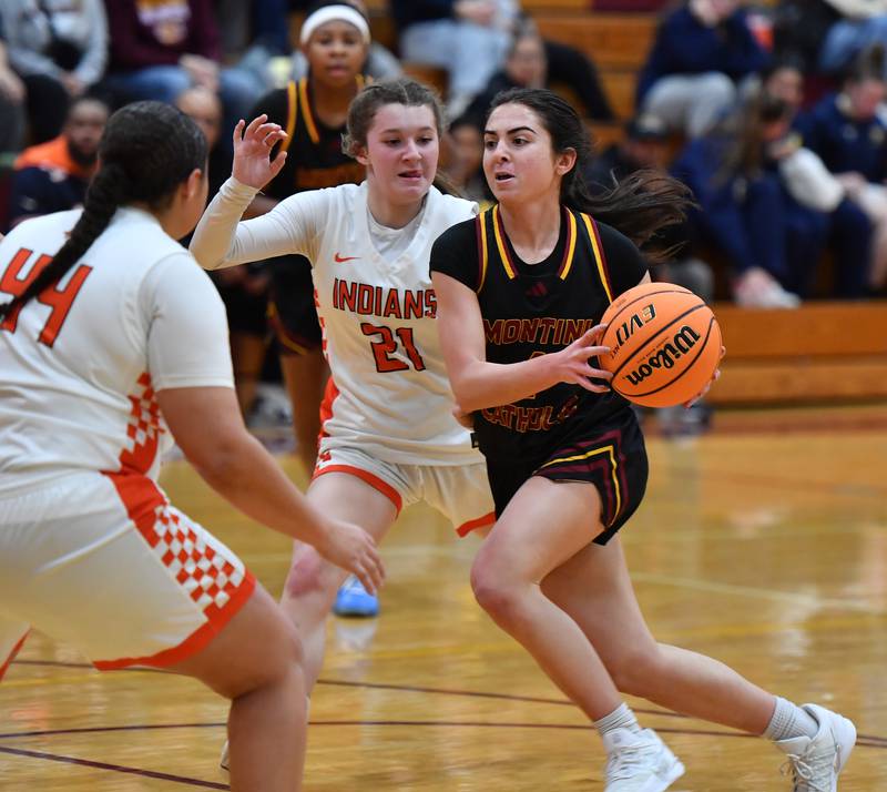 Montini’s Mia Quaranta drives to the basket as Minooka’s Sadie Webb (21) and Jaelle Hamilton (44) defend during a Montini Christmas Tournament game on December 22, 2025 at Montini Catholic High School in Lombard.