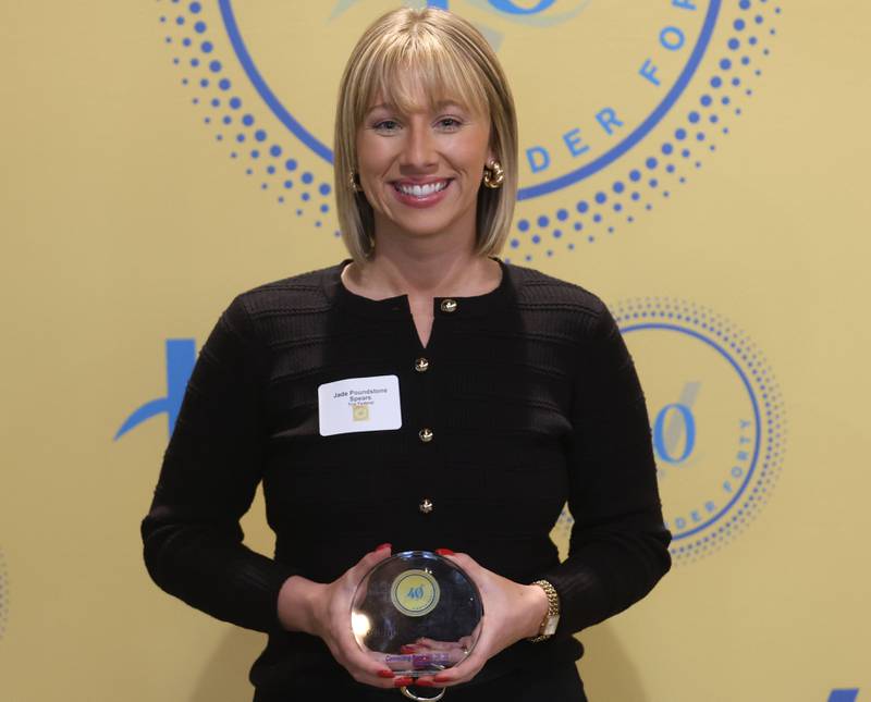 Jade Poundstone Spears poses with her 40 Under Forty award during the Illinois Valley Chamber of Commerce Champions of Change Awards Night on Wednesday, May 6, 2026 at the Westclox Event Center in Peru.
