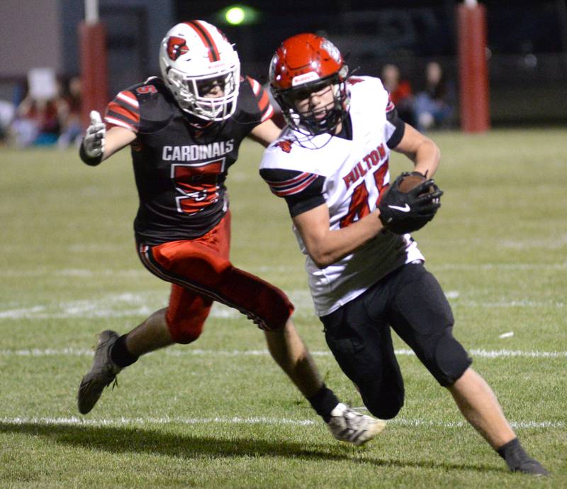 Fulton's Blaze Damhoff (45) runs with the ball as Foreston's Joseph Kobler (5) defends during a Friday, Sept. 12, 2025 NUIC game in Forreston.