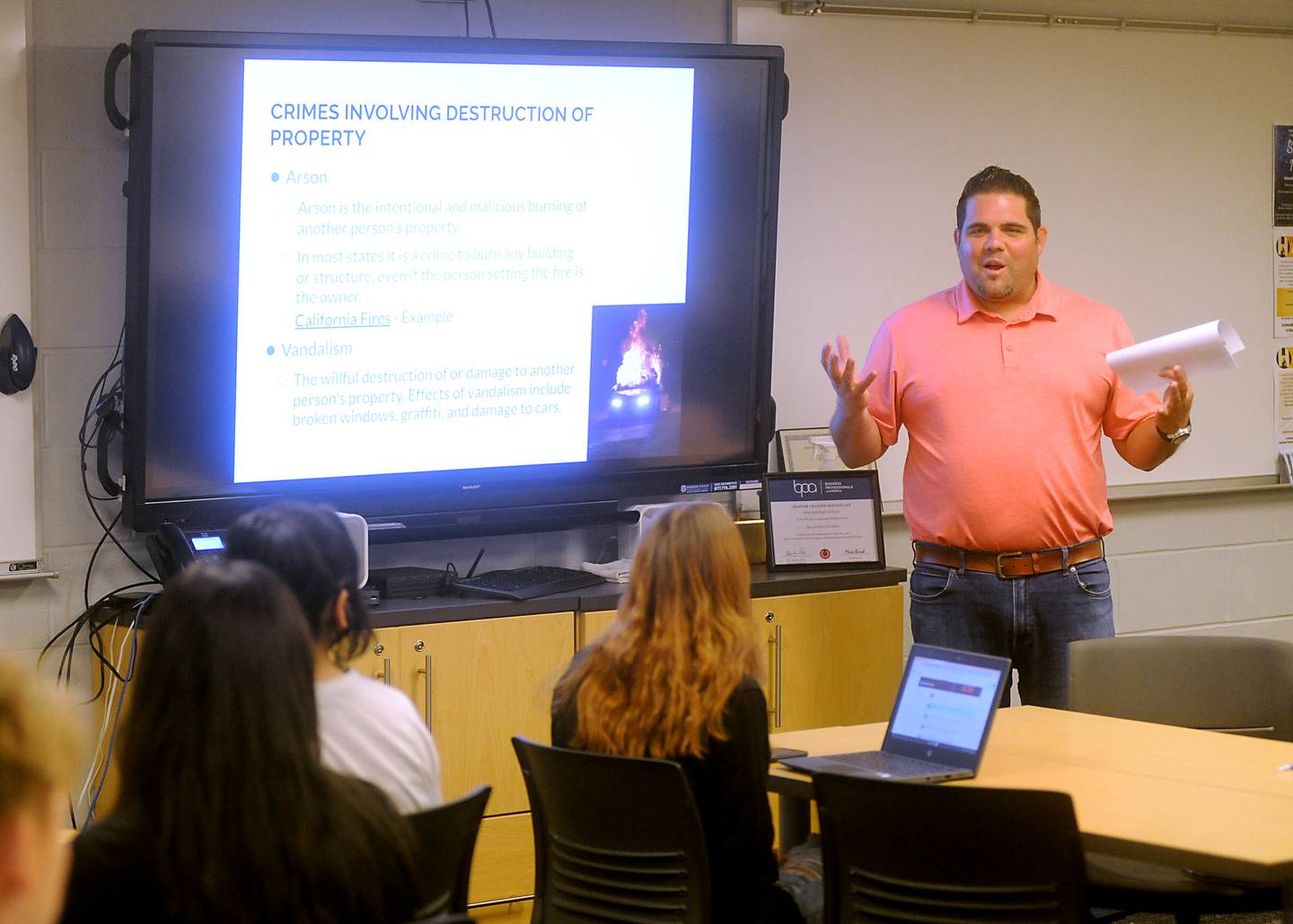 Harvard High School teacher Nick Valenziano teaches about different types of laws Wednesday, April 6, 2022, during a business law class.