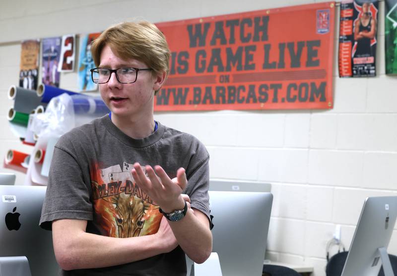 Owen Foster, a junior at DeKalb High School, talks Thursday, March 7, 2024, at the school, about what his experience has been like being a part of the BarbCast team. The BarbCast network broadcasts live streaming video of sports and events at the school as well as putting together promotional materials.